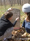 Examining an ancient gravestone close to the ruins of St. James church