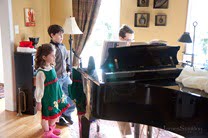 Ryan and Anna watch Daniel play his Christmas piece