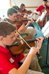 Jonathan and David play in the orchestra