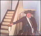 Reenactor poses by the banister at the house Washington used as a headquarters during the winter at Valley Forge
