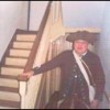 Reenactor poses by the banister at the house Washington used as a headquarters during the winter at Valley Forge